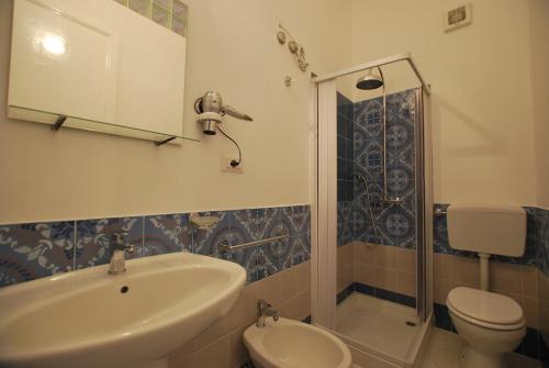 a bathroom with a sink and a toilet and a shower at Oasi 2 terrace overlooking the sea in Canneto in Canneto - Lipari