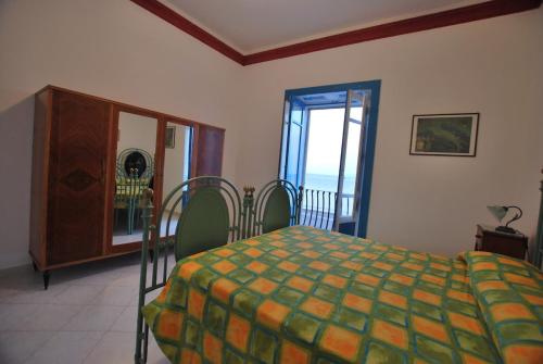 a bedroom with a bed and a table and chairs at Oasi 2 terrace overlooking the sea in Canneto in Canneto - Lipari