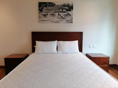 Ένα ή περισσότερα κρεβάτια σε δωμάτιο στο Cinnamon Life 2BR Apartment