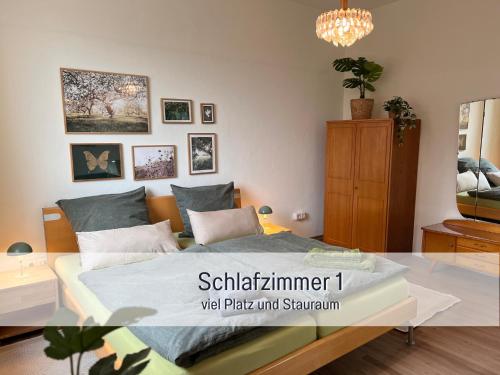 a bedroom with a bed with a glass table at Ferienwohnung am Maximilianpark Hamm in Hamm