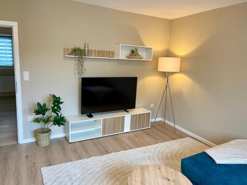 a living room with a flat screen tv on a wall at Lichtblick in Goldbach