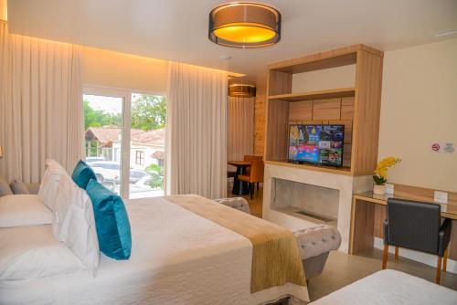 Ένα ή περισσότερα κρεβάτια σε δωμάτιο στο Pousada do Lago Penedo