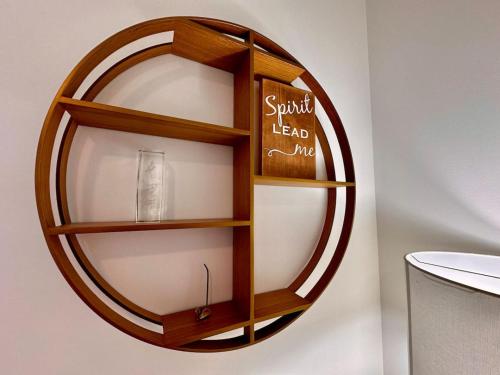 a wooden shelf on a wall with a glass at Golden Moments in Golden