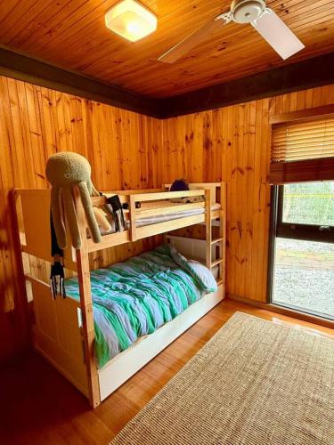 a bedroom with two bunk beds in a cabin at The Moona Cabin - Barwon Heads in Barwon Heads