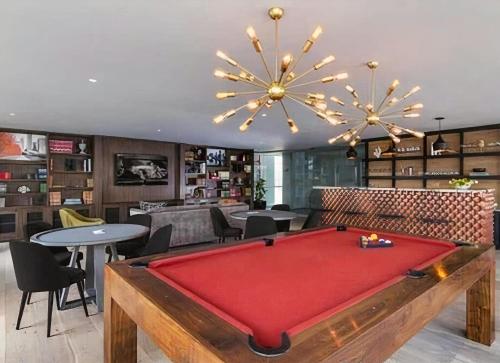 a living room with a pool table in the middle at Polanco Bohemian Luxury in Mexico City