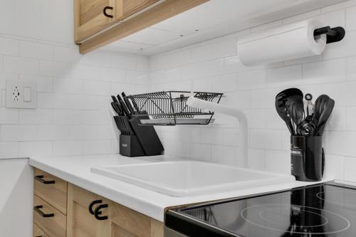 a kitchen counter with a sink and utensils at The Sherbrooke Suite 101 in Montreal