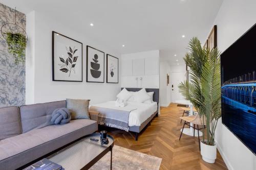 a living room with a bed and a couch at The Speakeasy Suite 502 With Parking in Montreal