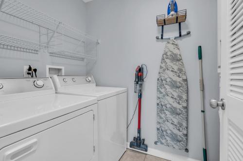 a white laundry room with a washing machine and a mop at Seaside Park Beach Home 3BR w Deck Peloton Parking 6 Beach Passes in Seaside Park