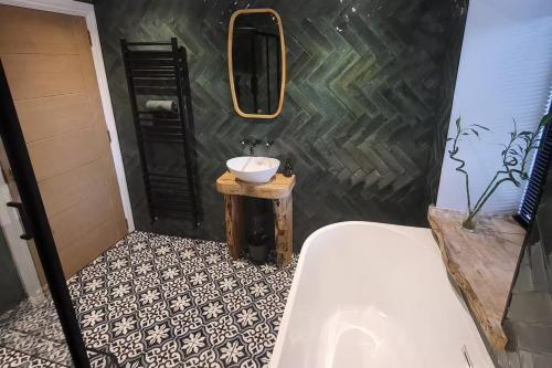 a bathroom with a sink and a mirror at 3 Bed House - Sea Views Balcony Parking Pets in Innellan