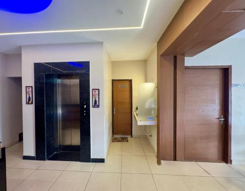 a hallway with two elevators in a building at The Rivanta Hotel Near Airport Road Mohali Zirakpur Chandigarh in Zirakpur