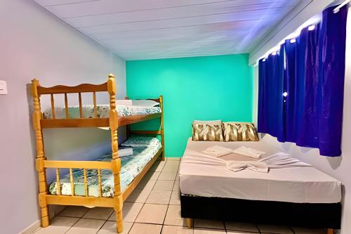 a small room with a bunk bed and a ladder at #PaRtiU PrAiA, 50 passos do Mar in Matinhos