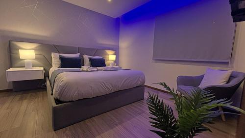 a purple bedroom with a bed and a chair at TOURAL HOUSE Villa in Arcos de Valdevez
