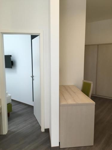 an empty room with a desk and a door at Hotel Fürsteneck in Bernburg