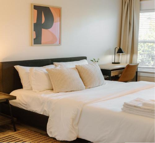 a bed with white sheets and pillows in a bedroom at Outsite San Diego - Golden Hill in San Diego