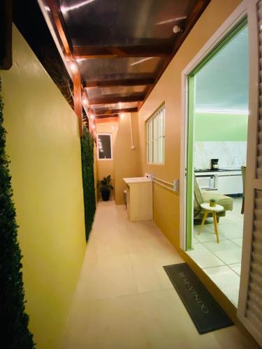 a room with a hallway with a window and a table at Casa das Oliveiras in Torres