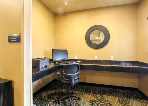 an office with a desk with a computer and a chair at Cobblestone Hotel & Suites - Devils Lake in Devils Lake