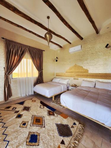 a bedroom with two beds and a large window at Urti Villa in Nzala