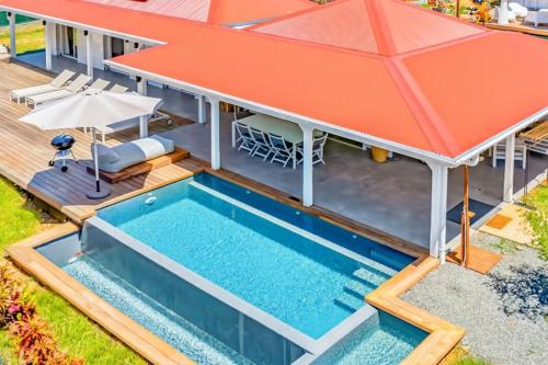 an overhead view of a house with a swimming pool and an orange roof at Villa Bohème in Terre-de-Haut