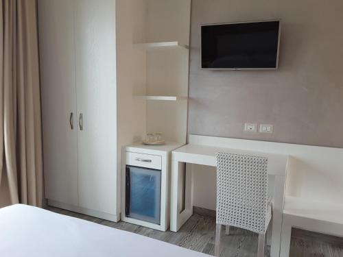 a bedroom with a desk and a table and a chair at Borgo di Santa Barbara in Santa Domenica