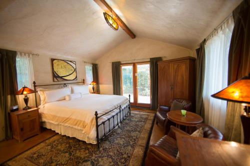 a bedroom with a bed and a living room at The Emerald Iguana Inn in Ojai