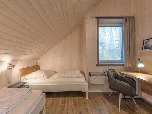 En eller flere senge i et værelse på Ferienhaus im Ferienpark Mirow
