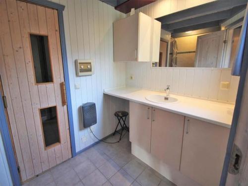 a small kitchen with a sink and a door at exklusives skandinavisches Ferienhaus in Granzow