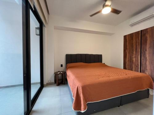 a bedroom with a bed and a ceiling fan at Place in the Romantic Zone with a Rooftop 301 in Puerto Vallarta