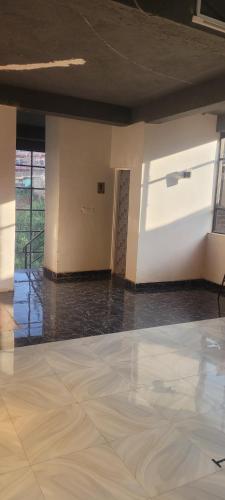 an empty room with a white wall and a floor at STERLEON HOTEL RIVERSIDE in Nairobi