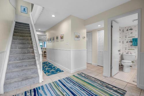 a bathroom with a staircase and a toilet at Beachy Vibes - 2BR w lake views & screened sunroom in Ponte Vedra Beach