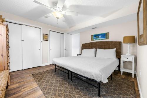 a bedroom with a bed and a ceiling fan at Oceanview Escape Private Beach Access in South Cocoa Beach