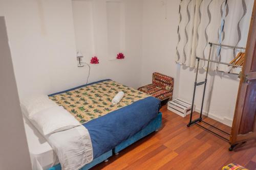 a small bedroom with a bed and a chair at Carmen Alto Inn Charming Private Rooms Steps from Downtown in Cusco