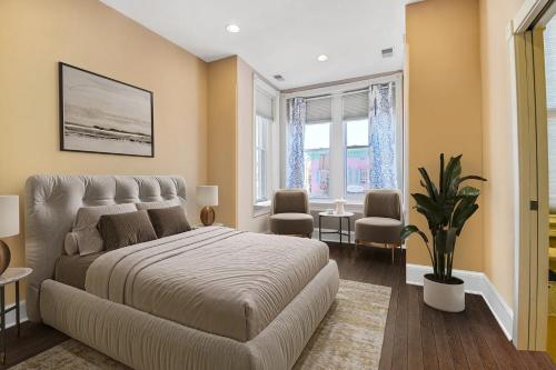 a bedroom with a large bed and a living room at Premier 5BR Historic Victorian Townhouse in Washington