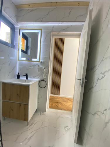 a bathroom with a sink and a mirror at Catunu lupului village Cabana Monte Benito in Cotorăşti