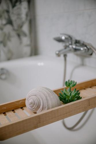 a wooden shelf in a bathroom with a bath tub at Ferienwohnung Landliebe in Pfullendorf
