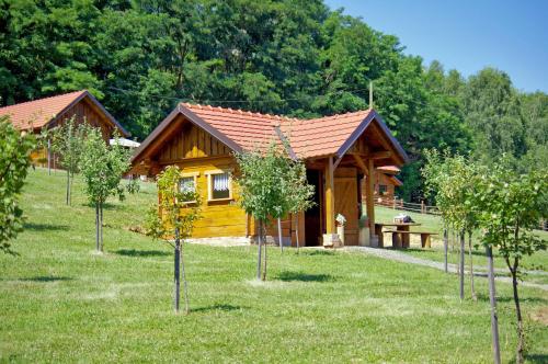 a small wooden cabin with trees in front of it at Grebengradska Medna Hiža in Donje Makojišće
