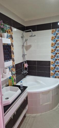 a bathroom with a tub and a sink at Villa in Meknès