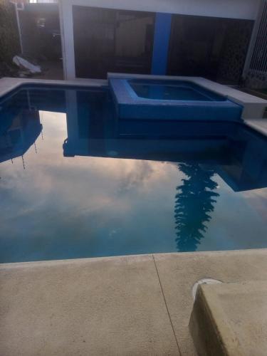 a pool of water with the sky in the water at Casa fin de semana en Cuernavaca Morelos in Cuernavaca