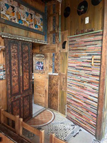 a room with a large wooden door and a wall at La mar in La Pedrera