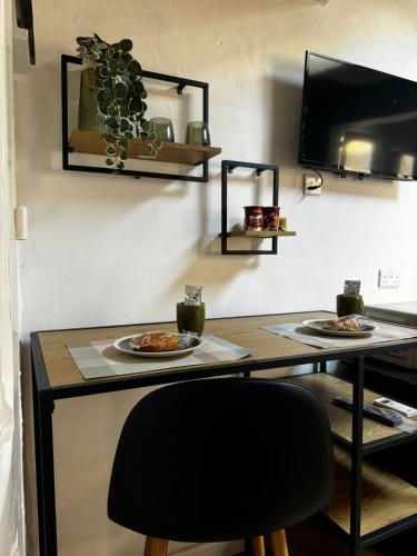 a table with two plates of food on it at Phi Home Bormla in Birgu