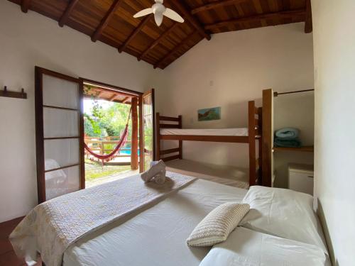 Ένα ή περισσότερα κρεβάτια σε δωμάτιο στο Pousada Paradise Ferrugem