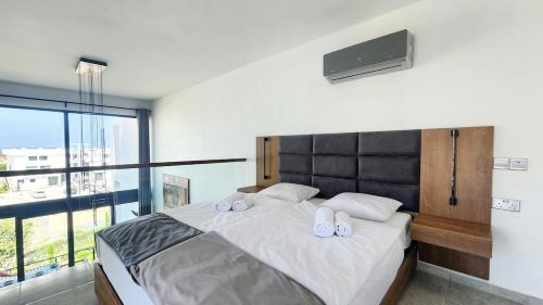 a bedroom with a large bed with slippers on it at Idyll Homes THE PENTHOUSE in Avdhelleron