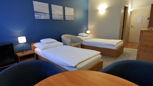 Ένα ή περισσότερα κρεβάτια σε δωμάτιο στο Varga-ház panzió