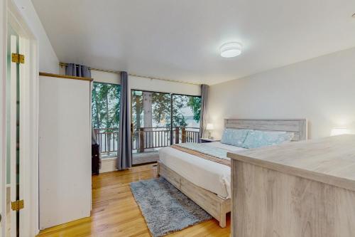 ein Schlafzimmer mit einem Bett und einem Balkon in der Unterkunft On Misty Tides in Port Gamble