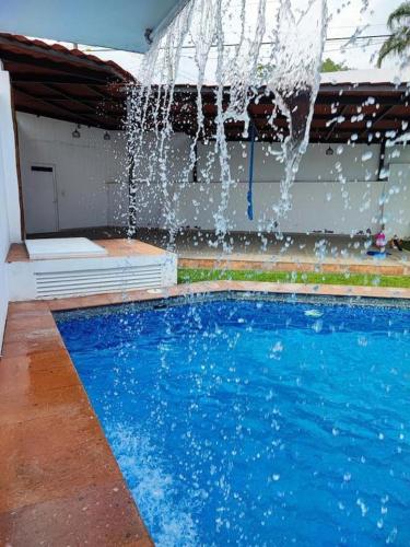 a swimming pool with a water fountain at Casa Jarana in Oaxtepec