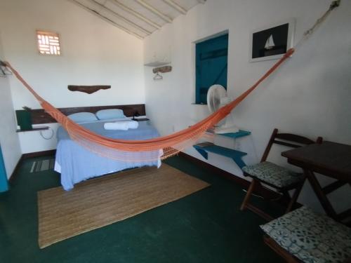 a bedroom with a hammock in a room at Cabanas Caraúbas II - ótimo visual do mar in Maxaranguape