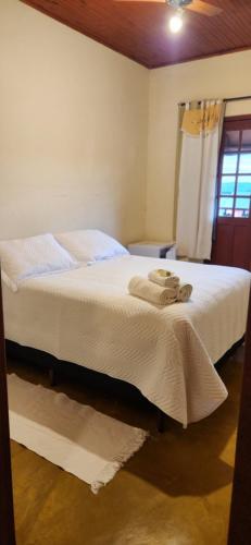 Ένα ή περισσότερα κρεβάτια σε δωμάτιο στο Pouso do Carteiro