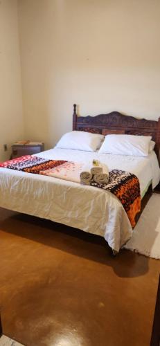 Ένα ή περισσότερα κρεβάτια σε δωμάτιο στο Pouso do Carteiro