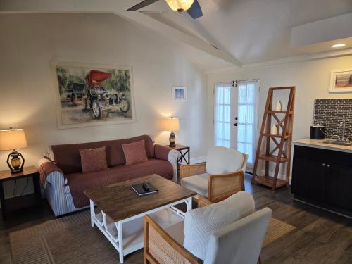 a living room with a couch and a table at Lamp Lighter Inn and Sunset Suites in Carmel