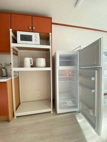 cocina con nevera abierta y microondas en 범계역2분 거리 퀸침대2개 무료주차가능 뚫린뷰가 일품, 