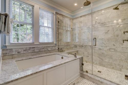 a bathroom with a tub and a glass shower at GE317: 317 Glen Eagle in Kiawah Island